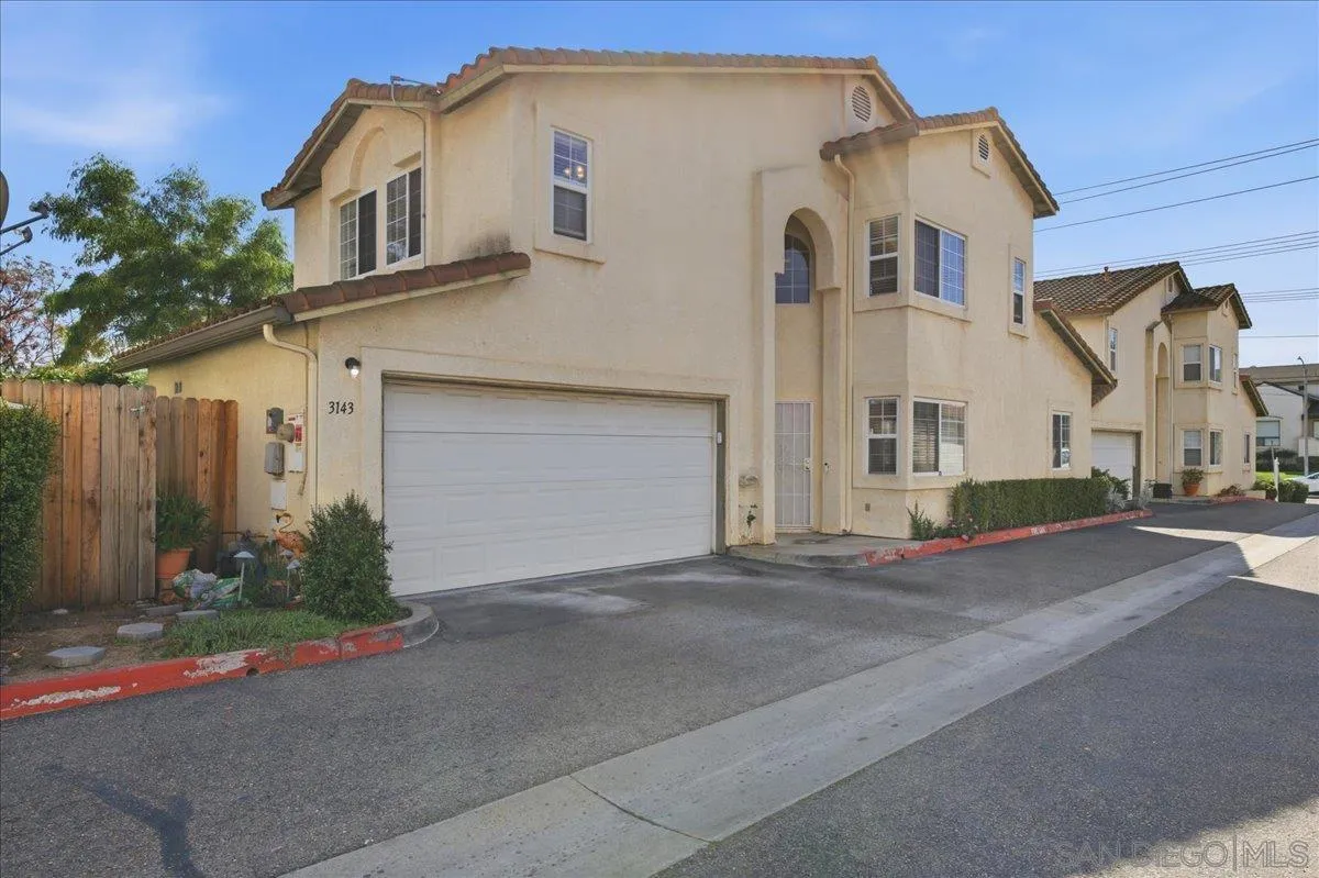 3143 Lamar Court Spring Valley, CA 91977 - Photo 2 of 40 a front view of a house with a yard and garage