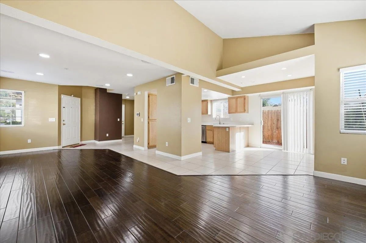 3143 Lamar Court Spring Valley, CA 91977 - Photo 5 of 40 a view of a living room with wooden floors and kitchen view