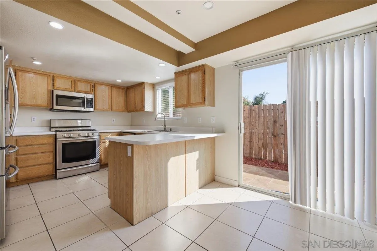 3143 Lamar Court Spring Valley, CA 91977 - Photo 6 of 40 a kitchen with stainless steel appliances granite countertop a stove a sink and a refrigerator