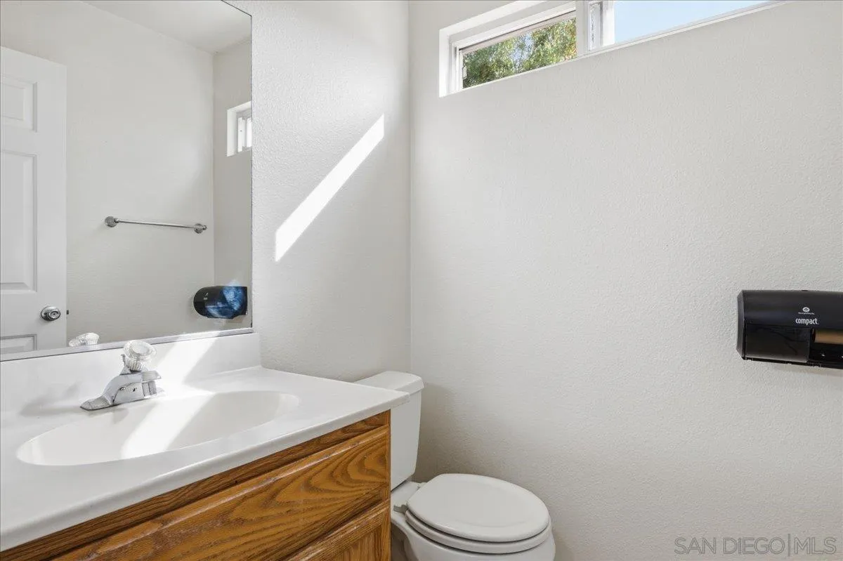 3143 Lamar Court Spring Valley, CA 91977 - Photo 9 of 40 a bathroom with a sink a toilet and mirror