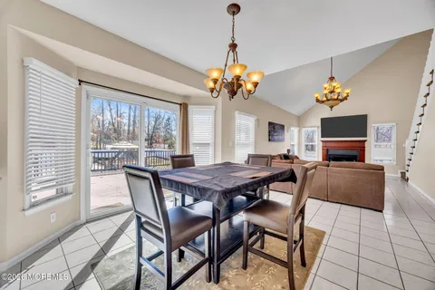 a large kitchen with granite countertop a sink and white cabinets