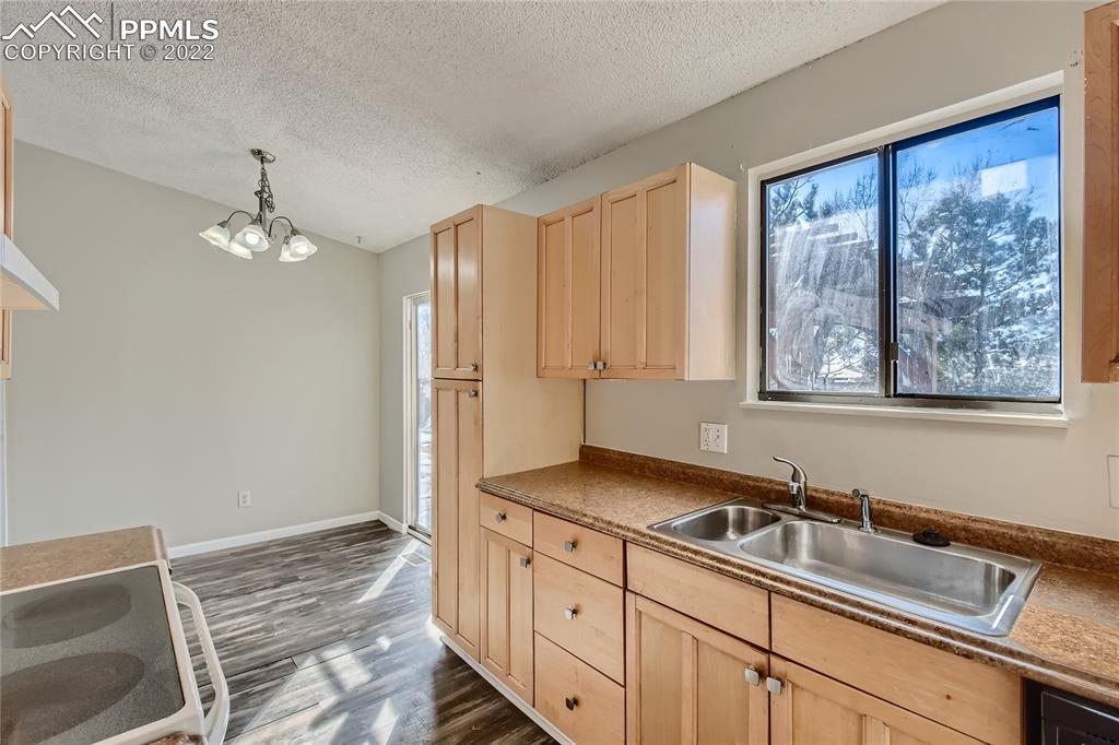 2030 Chelton Road Colorado Springs, CO 80916 - Photo 11 of 33 a hallway with a sink and a window