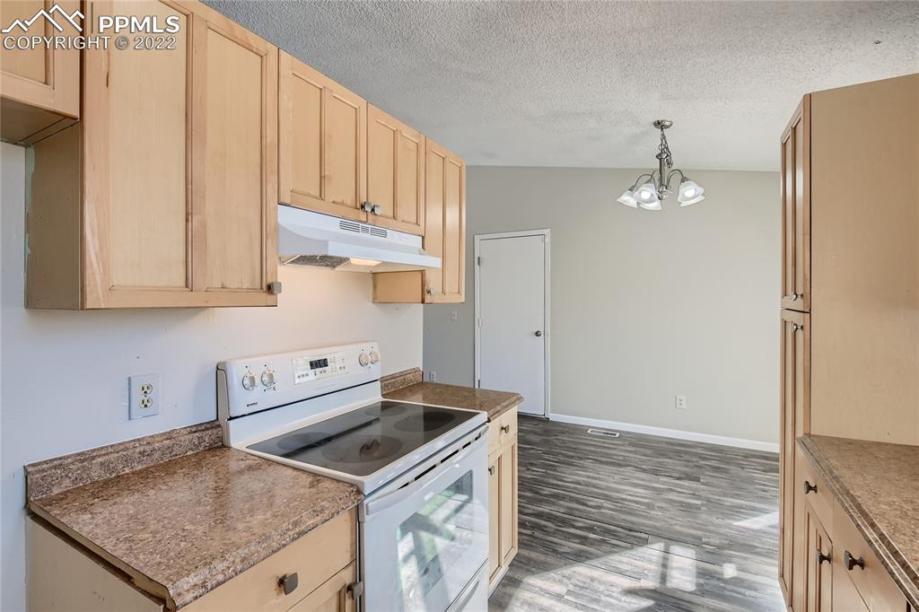 2030 Chelton Road Colorado Springs, CO 80916 - Photo 12 of 33 a kitchen with stainless steel appliances granite countertop a sink stove and refrigerator