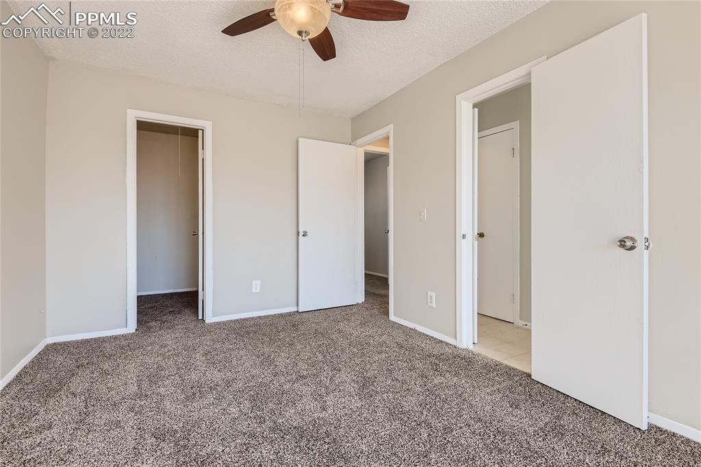 2030 Chelton Road Colorado Springs, CO 80916 - Photo 14 of 33 an empty room with chandelier fan