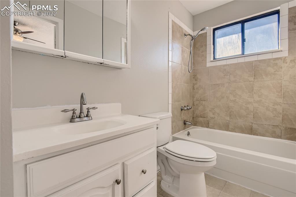 2030 Chelton Road Colorado Springs, CO 80916 - Photo 15 of 33 a bathroom with a sink a toilet and a bathtub