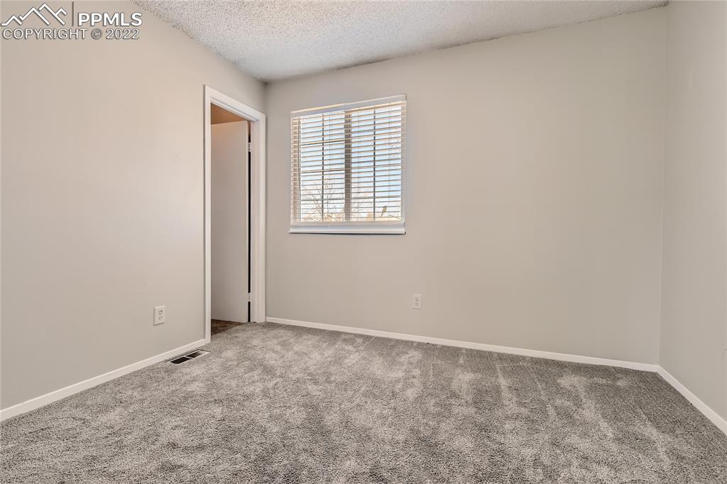 2030 Chelton Road Colorado Springs, CO 80916 - Photo 17 of 33 an empty room with windows