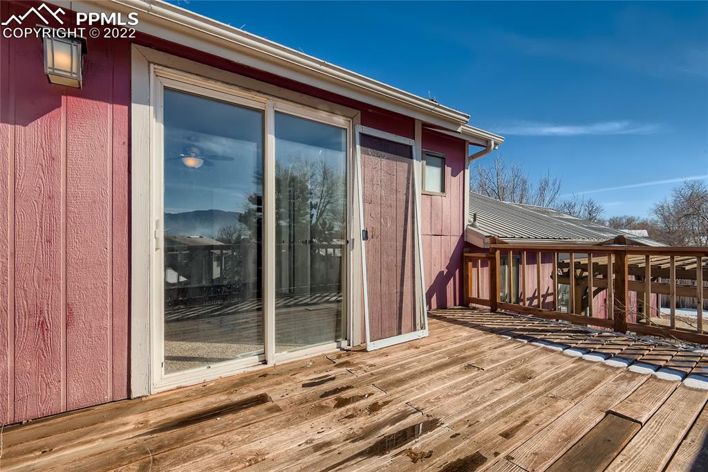 2030 Chelton Road Colorado Springs, CO 80916 - Photo 24 of 33 a backyard of a house with wooden floor barbeque oven and a glass door