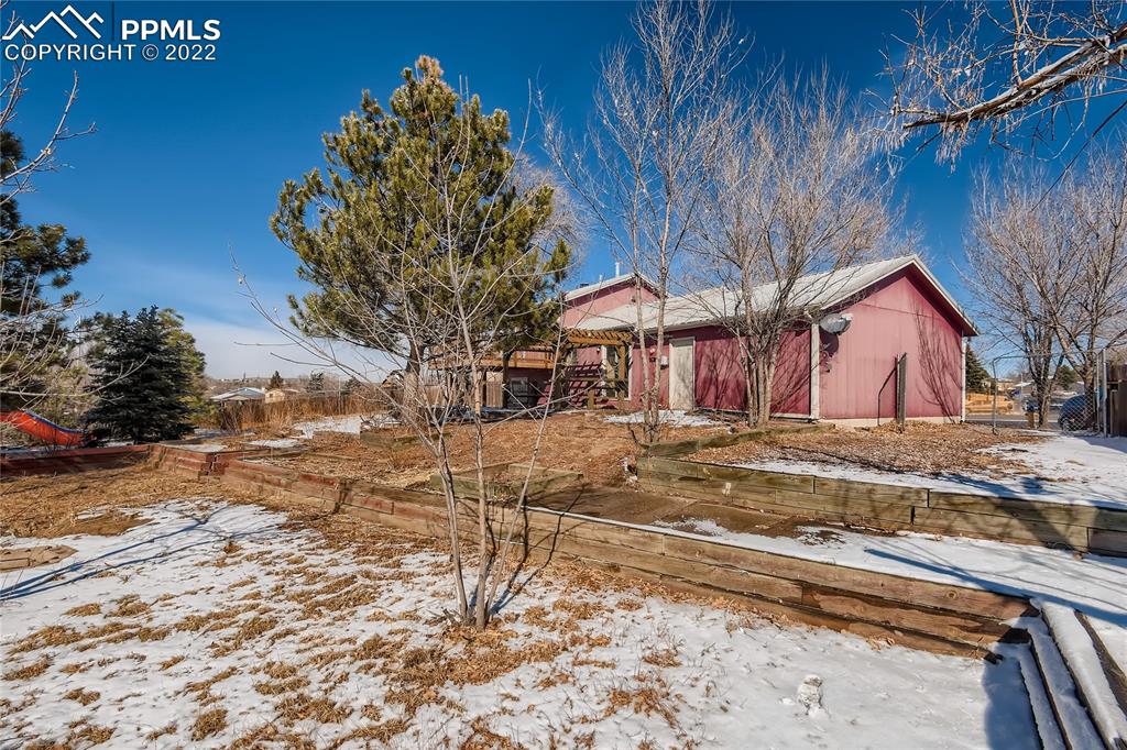 2030 Chelton Road Colorado Springs, CO 80916 - Photo 28 of 33 a view of a house with a snow yard