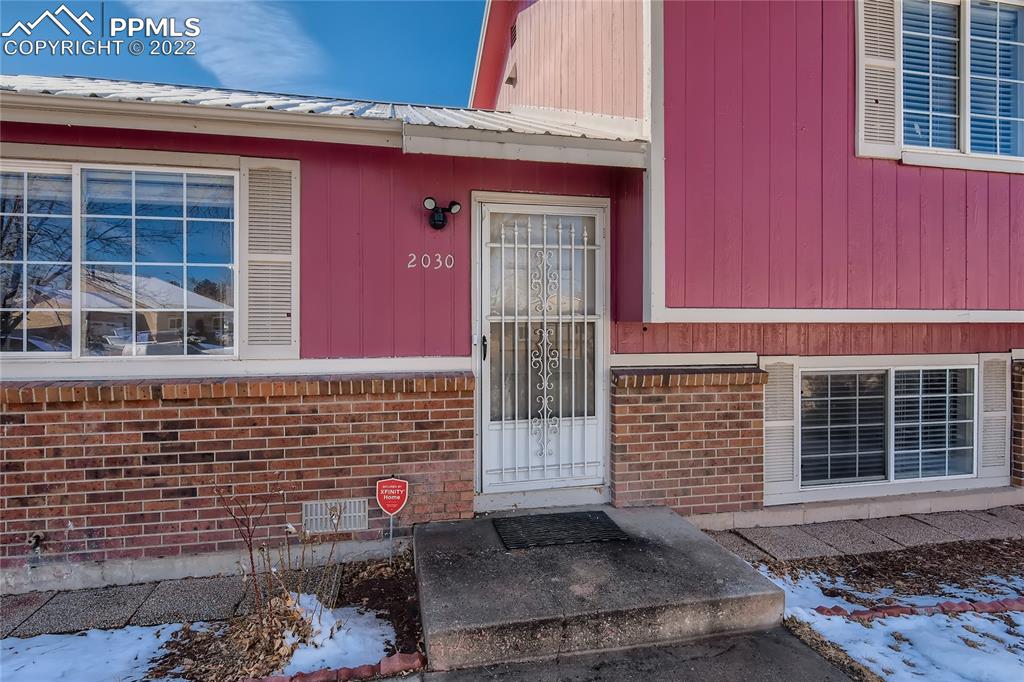2030 Chelton Road Colorado Springs, CO 80916 - Photo 3 of 33 a front view of a house with a yard