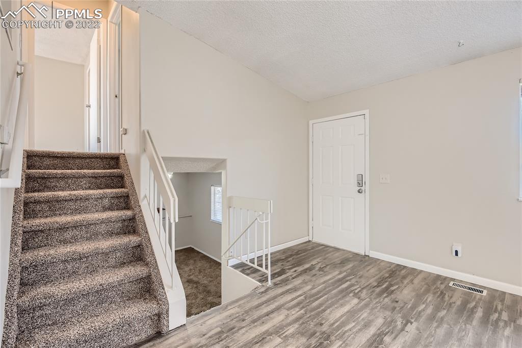2030 Chelton Road Colorado Springs, CO 80916 - Photo 5 of 33 a view of entryway with wooden floor