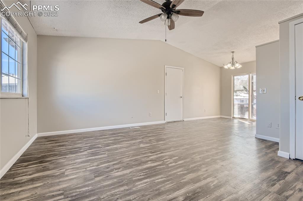 2030 Chelton Road Colorado Springs, CO 80916 - Photo 7 of 33 wooden floor in an empty room with a window