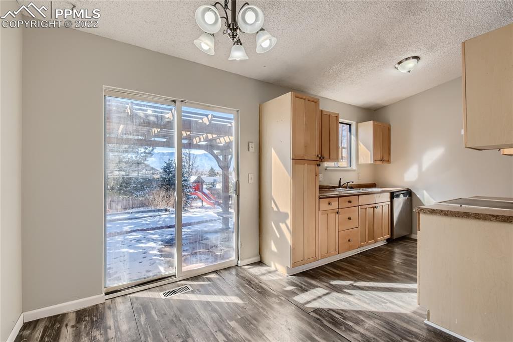2030 Chelton Road Colorado Springs, CO 80916 - Photo 8 of 33 a kitchen with granite countertop a stove top oven a refrigerator a sink and dishwasher