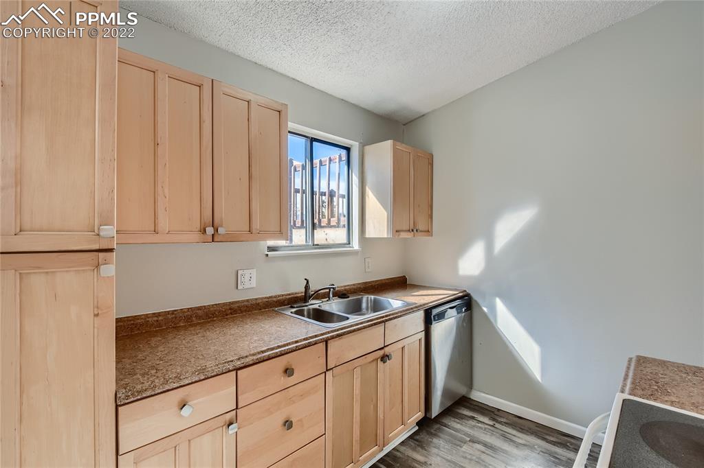 2030 Chelton Road Colorado Springs, CO 80916 - Photo 10 of 33 a kitchen with granite countertop a sink and a white cabinets