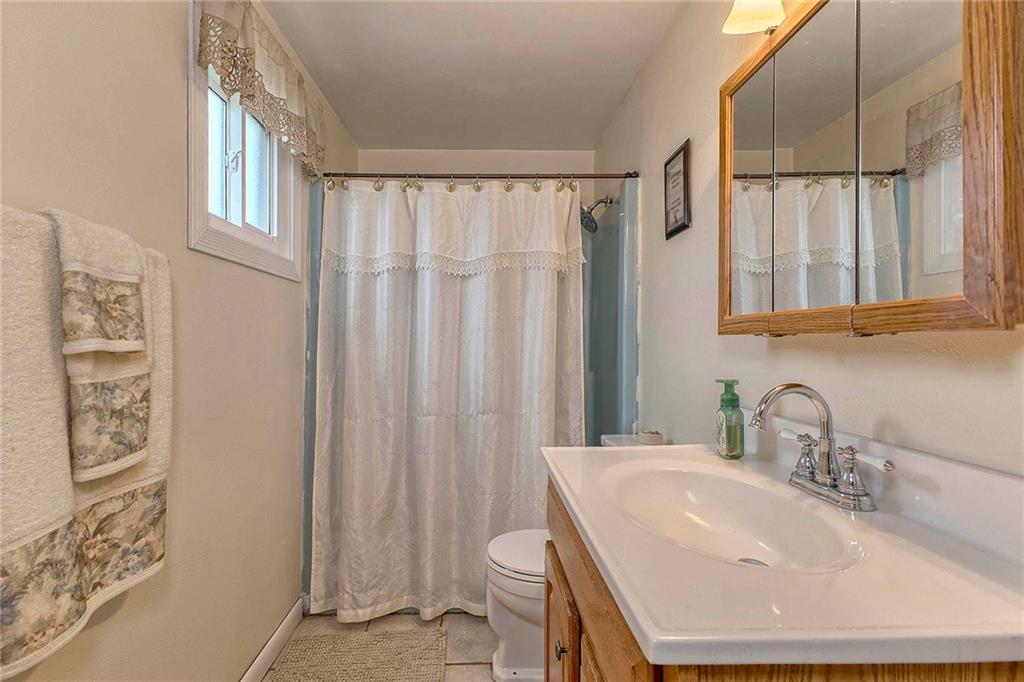 8002 Hayward Street Irwin, PA 15642 - Photo 16 of 31 a bathroom with a sink a toilet and a mirror
