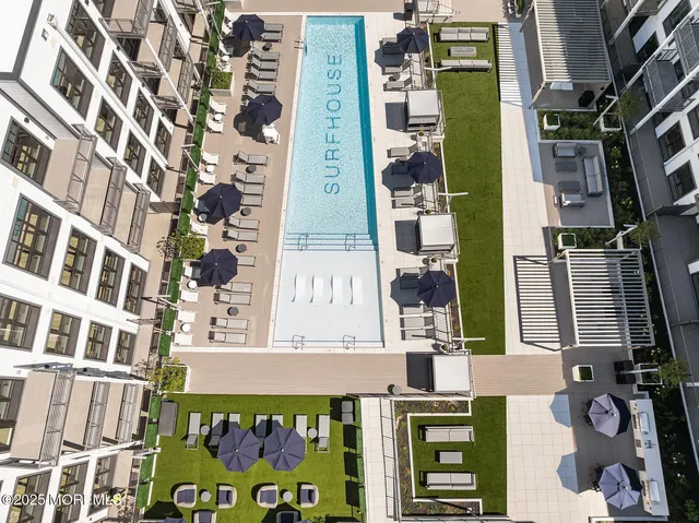 a swimming pool view with a outdoor seating