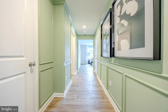 a view of a hallway with wooden floor