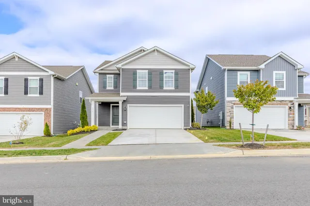 a kitchen with granite countertop lots of counter top space a sink stainless steel appliances and windows
