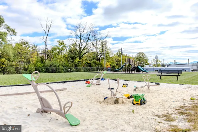 a bathroom with a granite countertop sink two mirror and shower