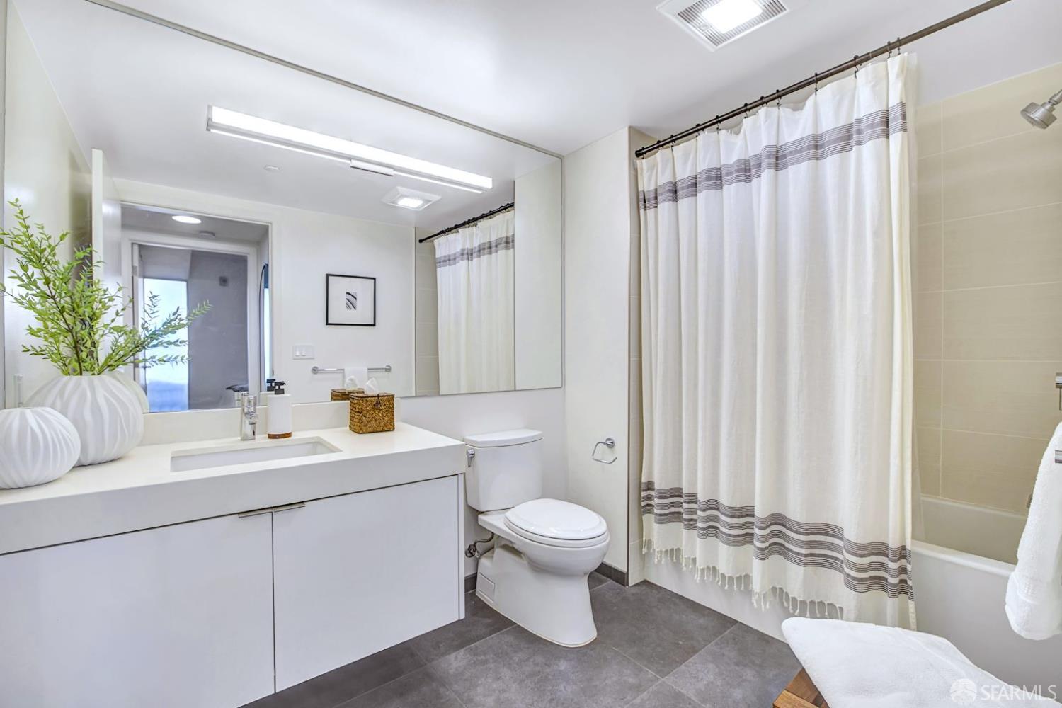 99 Rausch Street, Unit 214 San Francisco, CA 94103 - Photo 25 of 73 a view of bathroom with a toilet a sink and a mirror