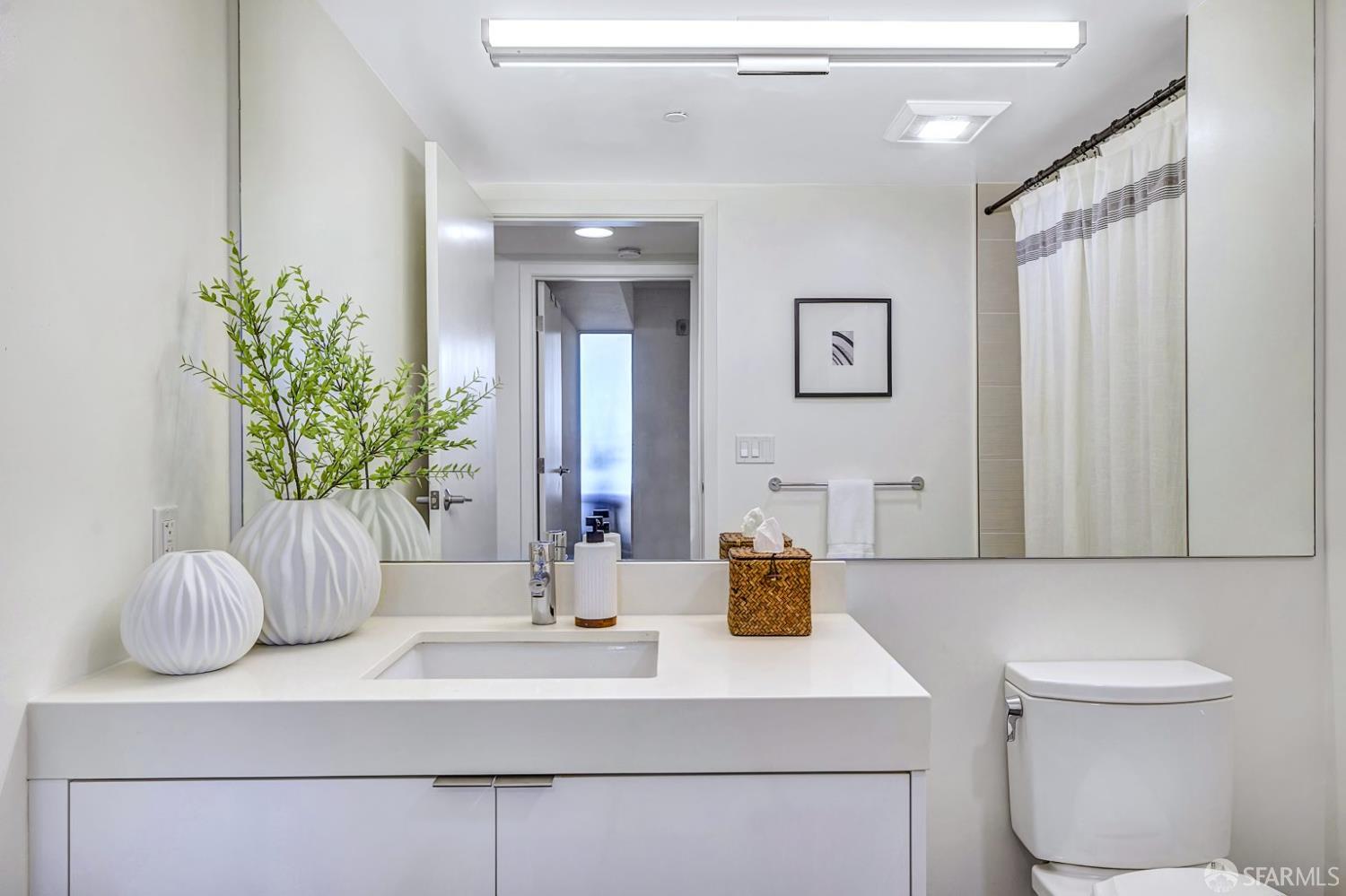99 Rausch Street, Unit 214 San Francisco, CA 94103 - Photo 26 of 73 a bathroom with a sink a toilet and mirror