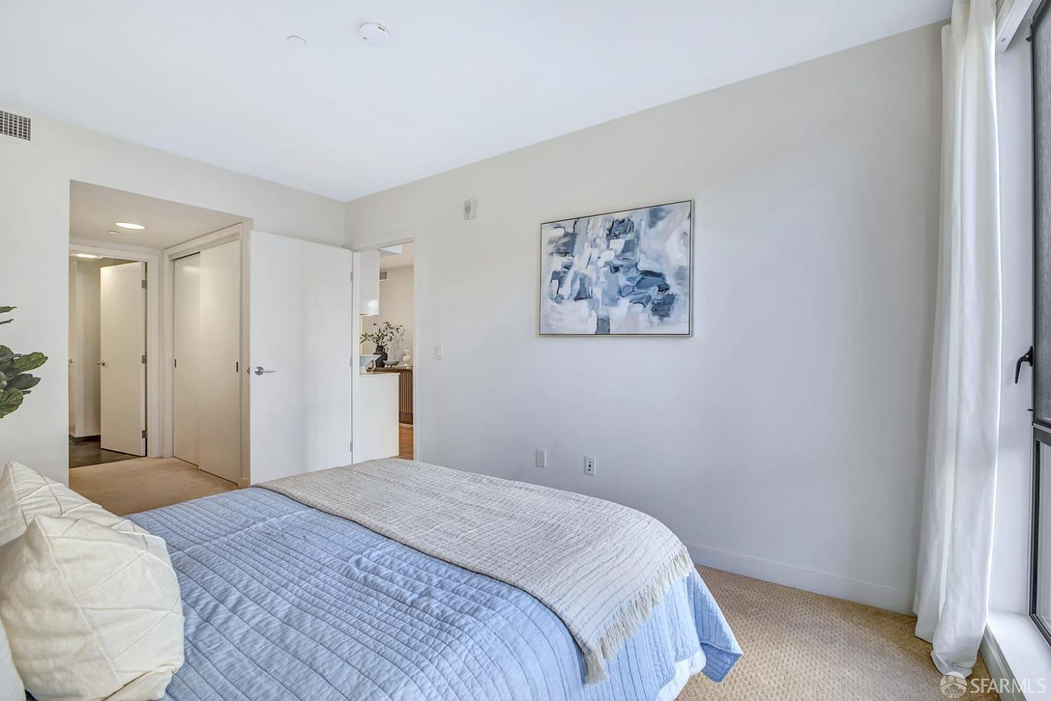 99 Rausch Street, Unit 214 San Francisco, CA 94103 - Photo 30 of 73 a bedroom with a large bed and a painting on the wall