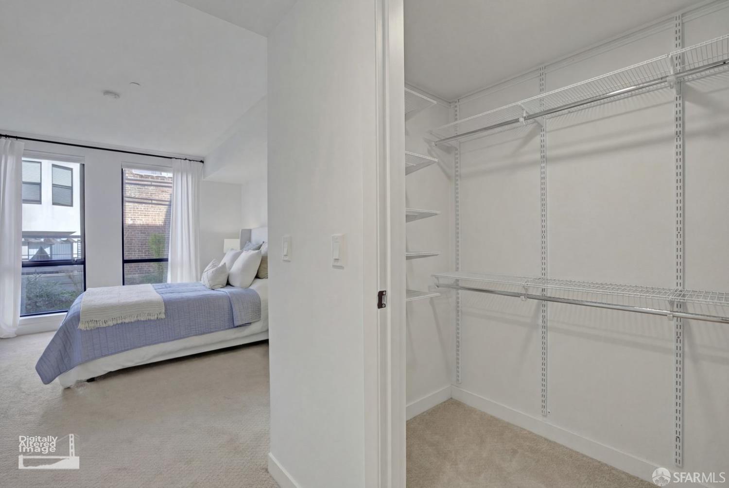 99 Rausch Street, Unit 214 San Francisco, CA 94103 - Photo 32 of 73 a bedroom with a bed and a chandelier