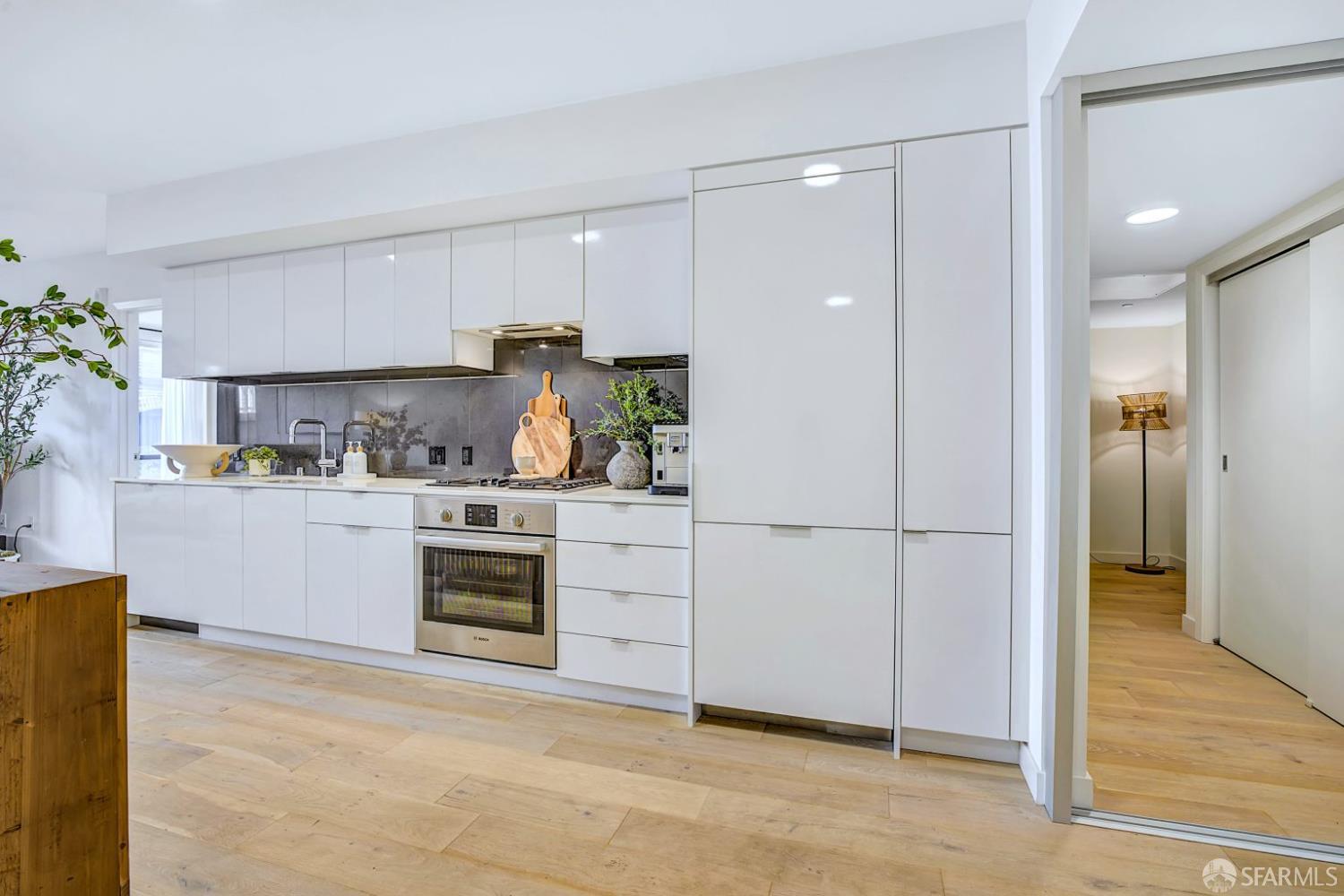 99 Rausch Street, Unit 214 San Francisco, CA 94103 - Photo 5 of 73 a kitchen with white cabinets and white appliances