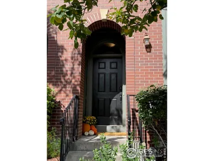 a front view of a house with a tree