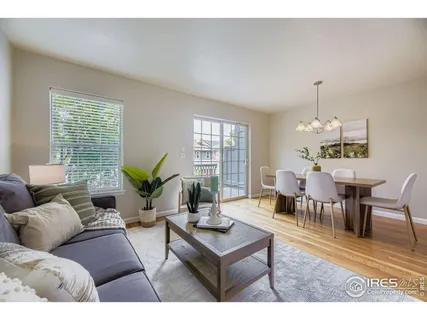 a living room with furniture potted plant and windows