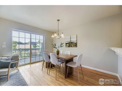 a dining room with furniture a chandelier and wooden floor