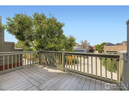a view of balcony with wooden floor and fence