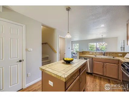 a kitchen with a stove a sink and a refrigerator
