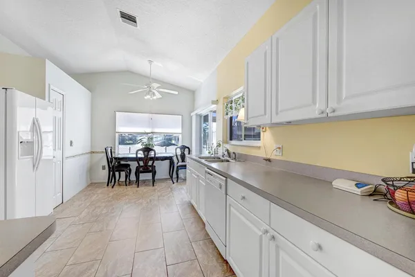 a kitchen with a white cabinets and white appliances