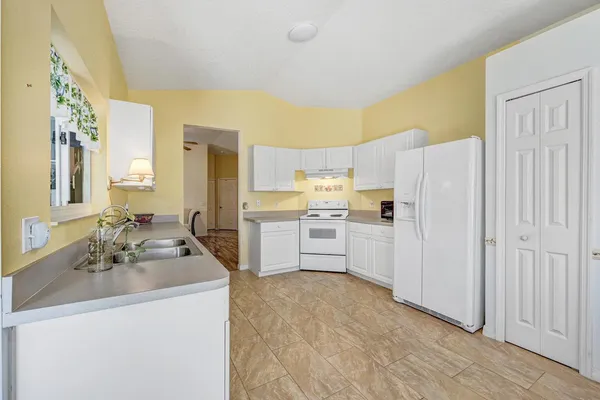 a dining room with furniture and a potted plant