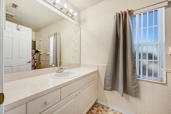 a bathroom with a toilet and shower curtain