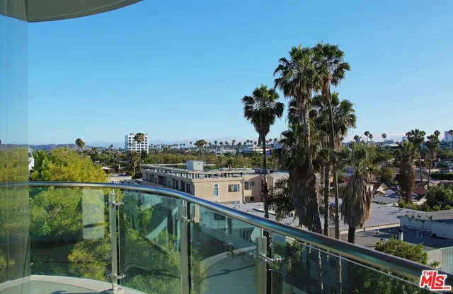 a view of a balcony next to a yard
