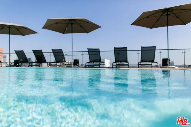 a kitchen with stainless steel appliances a sink a table and chairs