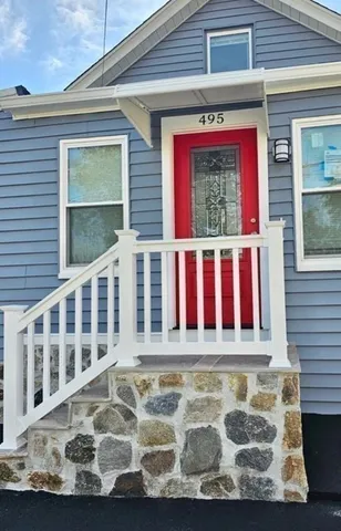 a view of a house with a small yard