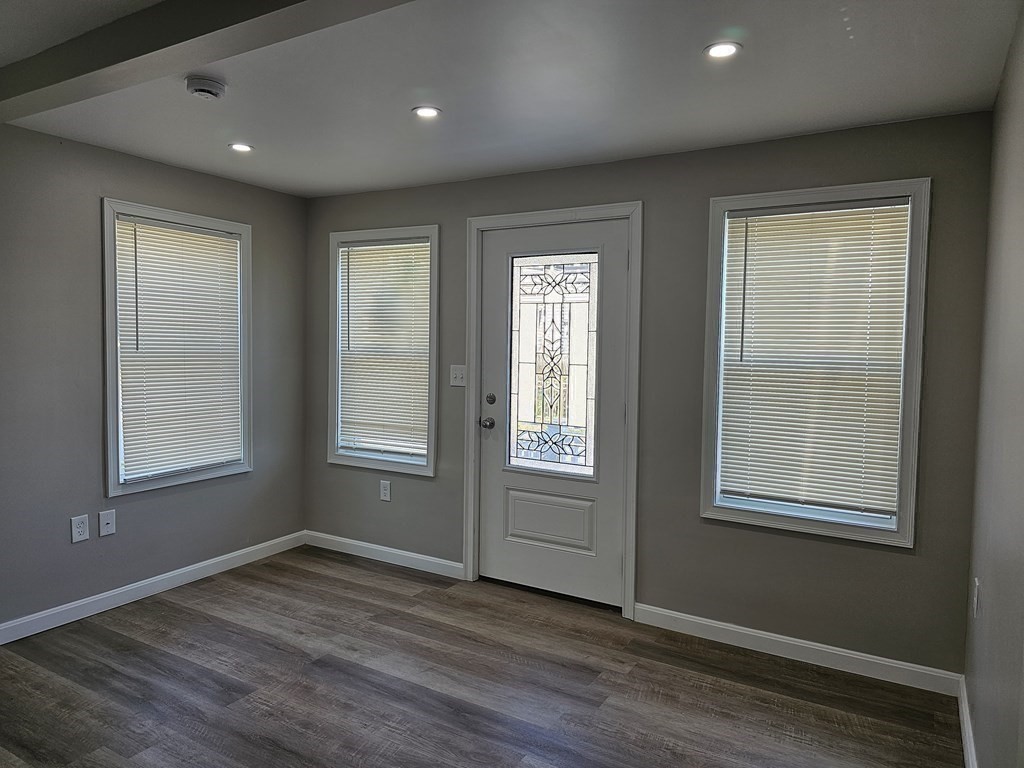 495 Chicago Street Fall River, MA 02721 - Photo 9 of 23 an empty room with wooden floor and windows