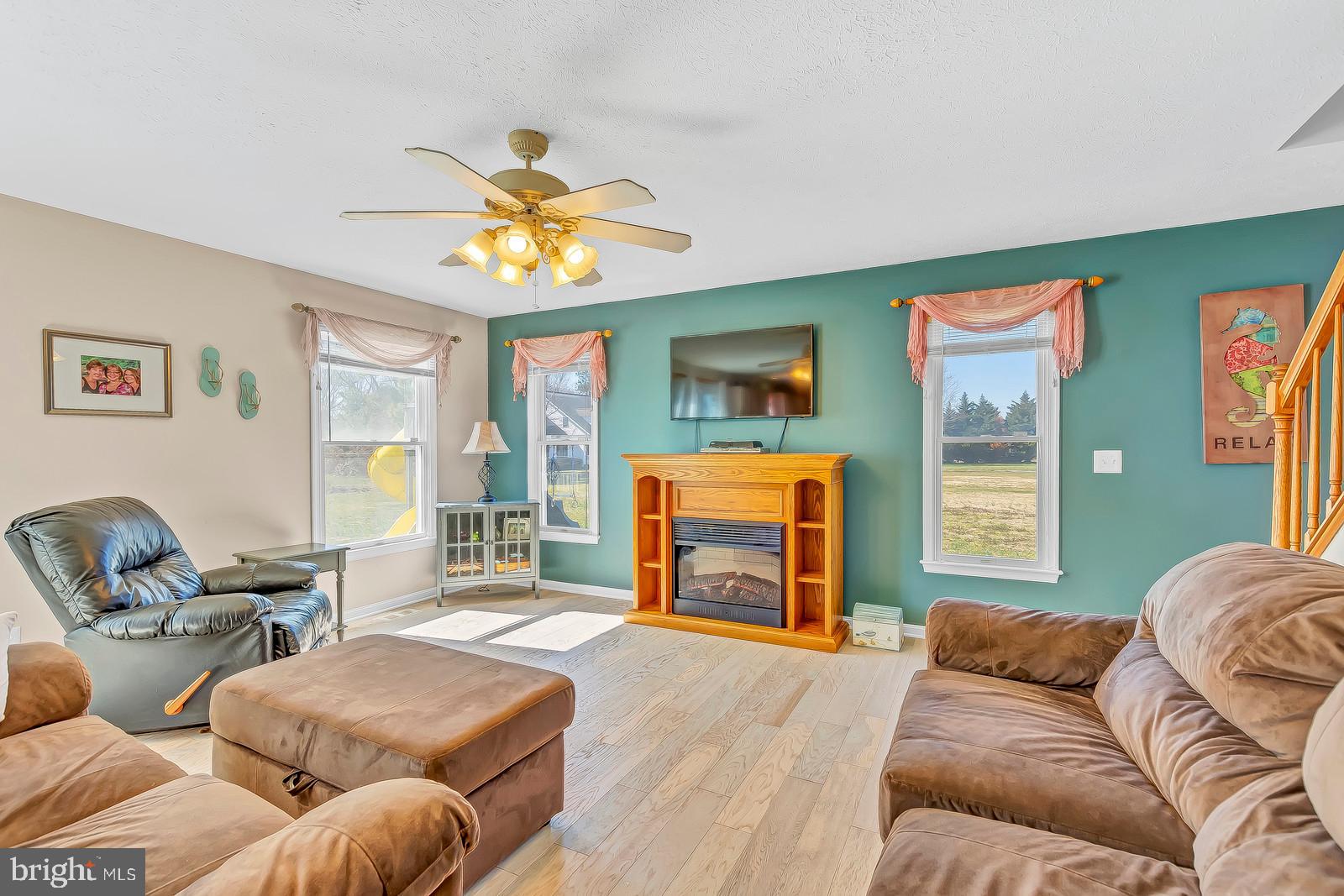 48948 Packer Court St. Inigoes, MD 20684 - Photo 15 of 45 a living room with furniture a fireplace and a flat screen tv