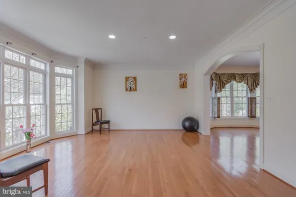 a view of a room with wooden floor and window