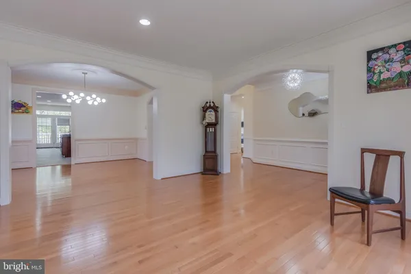 a hallway with wooden floor and flower pot