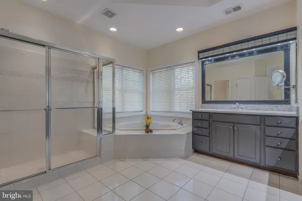 a white bath tub sitting next to a toilet
