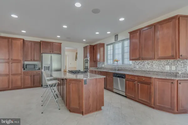 a kitchen with stainless steel appliances granite countertop a stove and a refrigerator