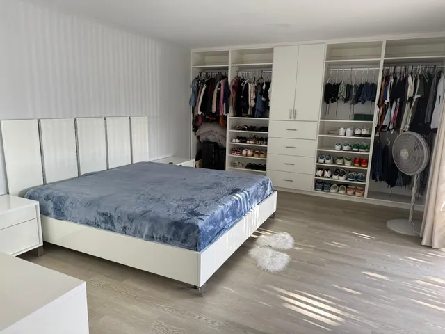 a bedroom with a bed and closet