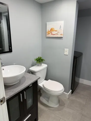a bathroom with a toilet a sink and a mirror