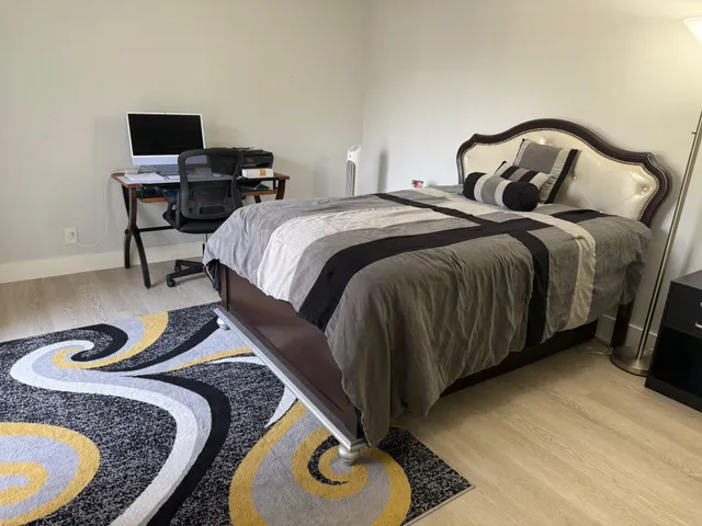 a bedroom with bed and a chair