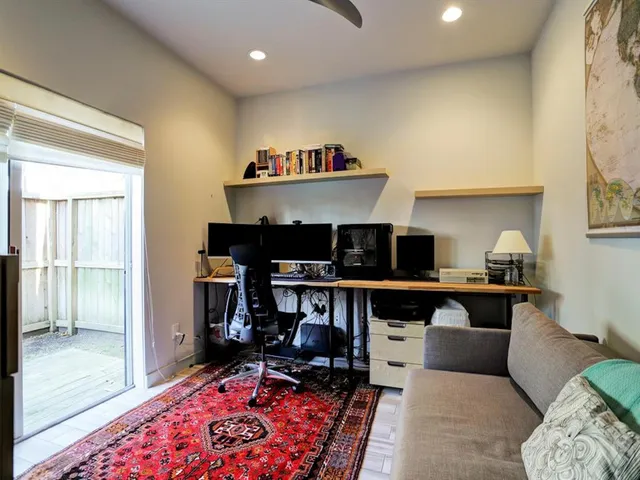 a living room with furniture a rug and a window