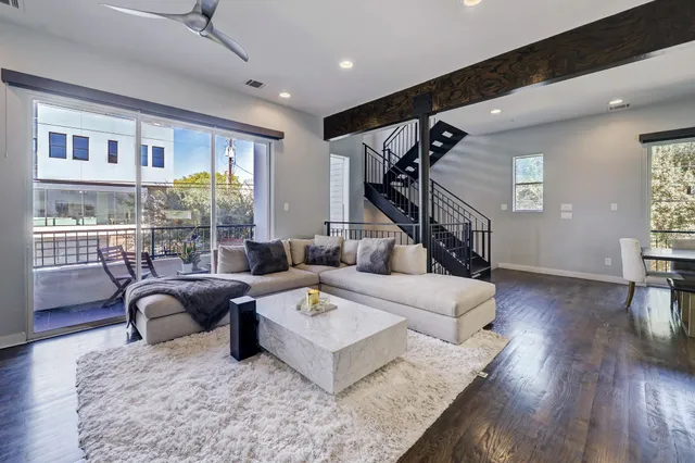 a living room with furniture and a floor to ceiling window