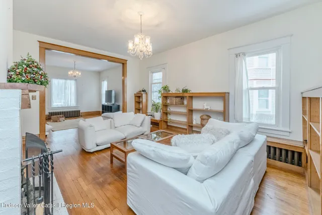 a living room with furniture and a chandelier
